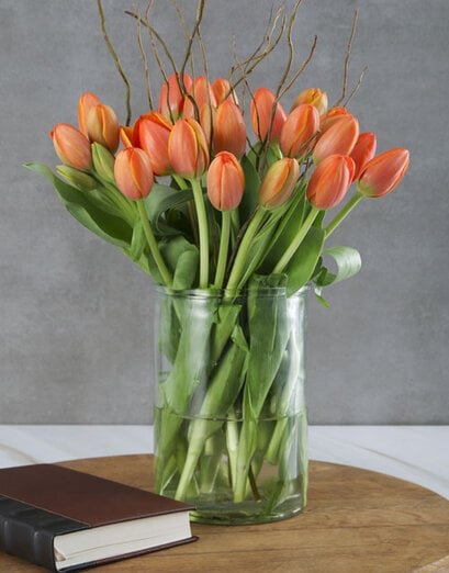Sun Kissed Tulips In Clear Vase