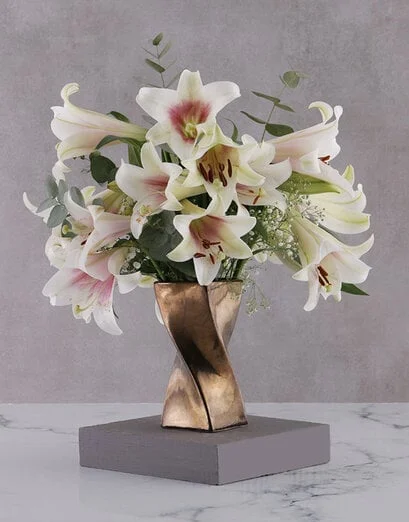 St Joseph Lilies in Twisty Bronze Vase - Product image