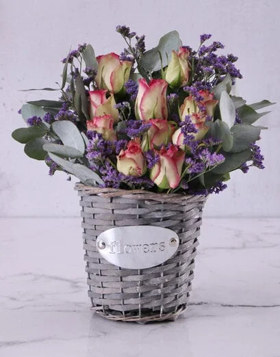 Variegated Roses In A Grey Basket - Product image